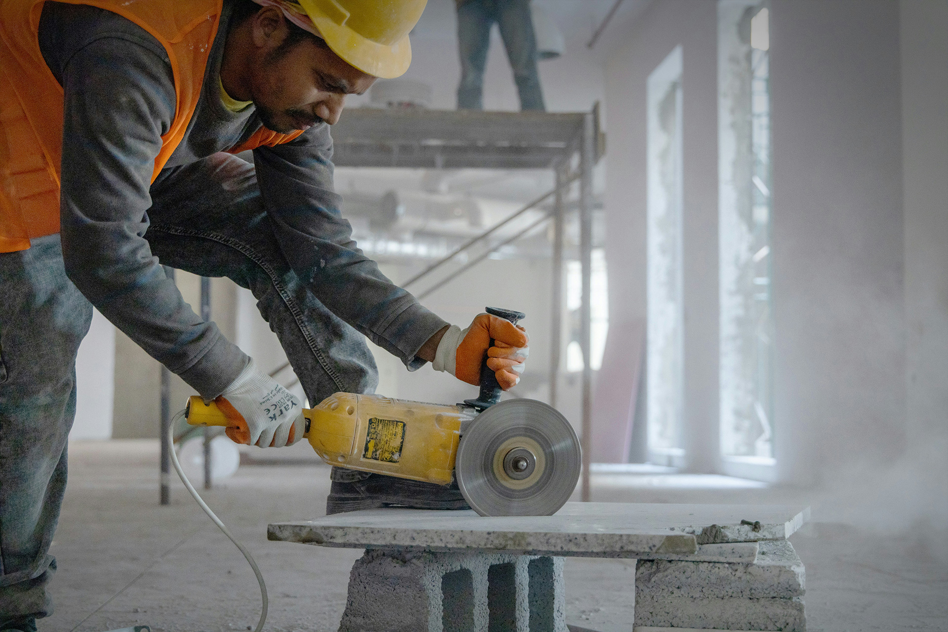 construction worker using a grinder
